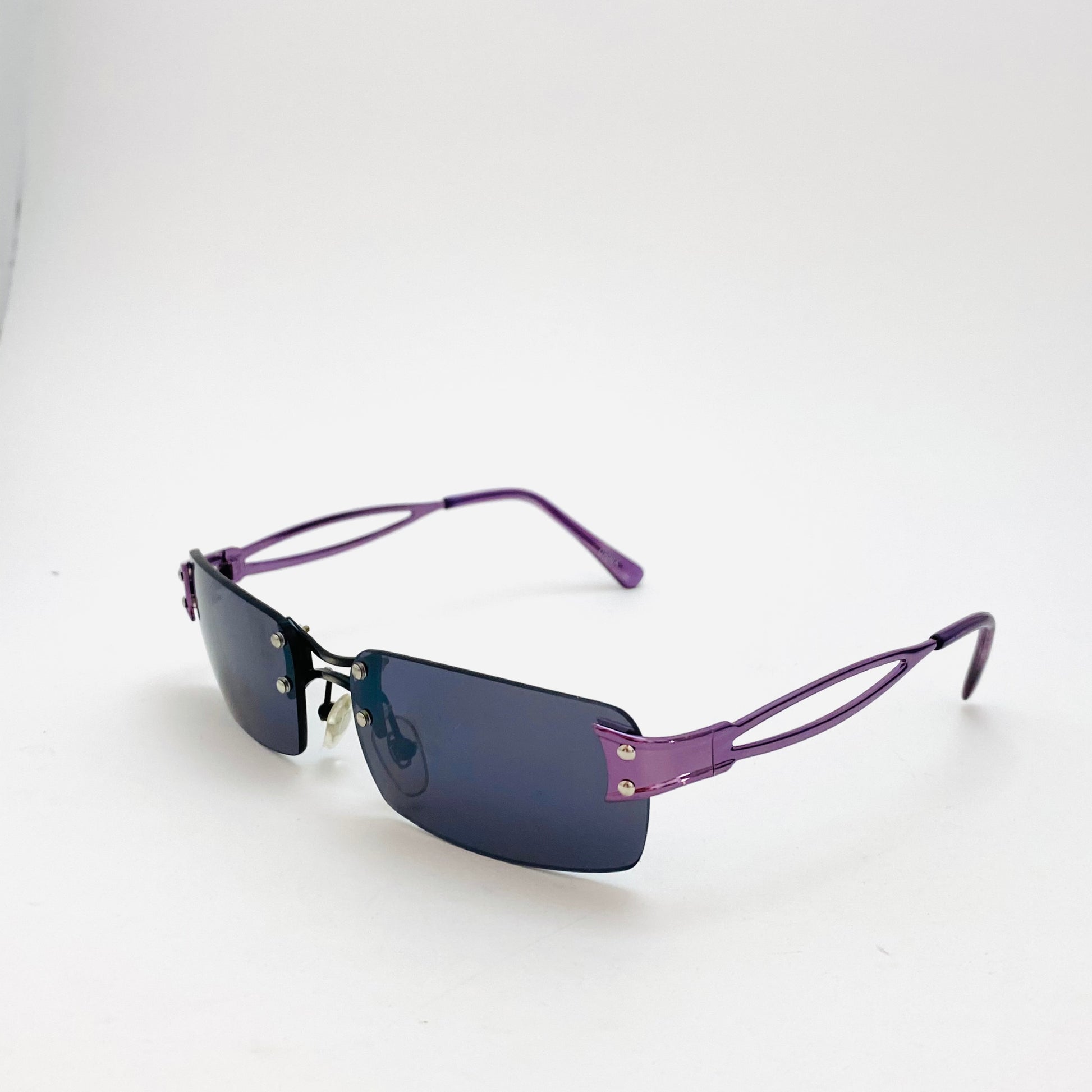 grunge style, dark lens, rimless deadstock sunglasses with purple color
